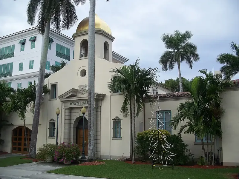 Boca Raton's Old Town Hall, a gold-domed stucco building framed by palms